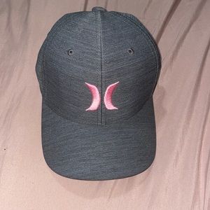 It is gray, with the pink logo, size S-M.  Brand new.